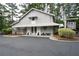 Charming two-story gray building with a covered front porch, offering a welcoming entrance and quaint architectural details at 4205 Jim Owens Nw Rd, Kennesaw, GA 30152