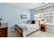 Bedroom with wood bed frame and light blue walls at 724 Landsdowne Ln, Locust Grove, GA 30248