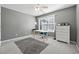 Home office or bedroom with window and neutral decor at 724 Landsdowne Ln, Locust Grove, GA 30248