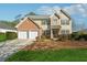 Brick and siding two-story house with a two-car garage and landscaped lawn at 724 Landsdowne Ln, Locust Grove, GA 30248
