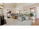 Bright Gathering room with sectional sofa, fireplace and view into dining area at 724 Landsdowne Ln, Locust Grove, GA 30248