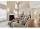 Two-story Gathering room with a fireplace and large sectional sofa at 724 Landsdowne Ln, Locust Grove, GA 30248