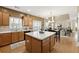 Open kitchen features an island and views into the living room at 724 Landsdowne Ln, Locust Grove, GA 30248