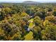 Aerial view showcasing a house nestled in a wooded area with mountain views at 1352 Jennie Sw Ln, Lilburn, GA 30047