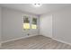 Simple bedroom with two windows and wood-look flooring at 1352 Jennie Sw Ln, Lilburn, GA 30047