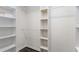 Large walk-in closet with built in shelving and hanging rods at 1352 Jennie Sw Ln, Lilburn, GA 30047