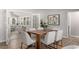 Light-filled dining area with wood table, white chairs, and access to sunroom at 1352 Jennie Sw Ln, Lilburn, GA 30047