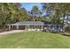 Newly renovated ranch home with gray siding, spacious lawn, and long driveway at 1352 Jennie Sw Ln, Lilburn, GA 30047