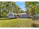 Gray house with sunroom and large backyard at 1352 Jennie Sw Ln, Lilburn, GA 30047