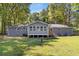 Gray house with sunroom and large backyard at 1352 Jennie Sw Ln, Lilburn, GA 30047