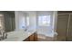Primary bathroom with double vanity and soaking tub at 1432 Cutters Mill Dr, Lithonia, GA 30058