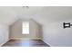 Unfinished attic bedroom with window and laminate flooring at 1432 Cutters Mill Dr, Lithonia, GA 30058