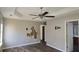 Primary bedroom with ceiling fan and needs minor repair at 1432 Cutters Mill Dr, Lithonia, GA 30058