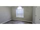 Bright bedroom featuring an arched window and laminate flooring at 1432 Cutters Mill Dr, Lithonia, GA 30058