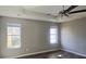 Primary bedroom with ceiling fan and ample natural light at 1432 Cutters Mill Dr, Lithonia, GA 30058