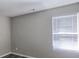Spacious bedroom with window and neutral walls at 1432 Cutters Mill Dr, Lithonia, GA 30058