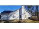 Side view of house with yard and wooden fence at 1432 Cutters Mill Dr, Lithonia, GA 30058