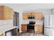 Modern kitchen featuring stainless steel appliances and light wood cabinets at 1432 Cutters Mill Dr, Lithonia, GA 30058