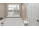 Bathroom with soaking tub and window at 2114 Black Oak Ln, Ellenwood, GA 30294