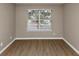 Simple bedroom with hardwood floors and a large window at 2114 Black Oak Ln, Ellenwood, GA 30294
