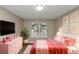 Cozy bedroom with pink accents and plenty of natural light at 2114 Black Oak Ln, Ellenwood, GA 30294