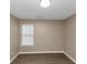 Bright bedroom featuring wood-look floors and a window with blinds at 2114 Black Oak Ln, Ellenwood, GA 30294