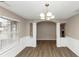 Bright dining room features hardwood floors and wainscoting at 2114 Black Oak Ln, Ellenwood, GA 30294