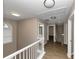 Upstairs hallway with hardwood floors and access to bedrooms at 2114 Black Oak Ln, Ellenwood, GA 30294