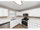 Modern kitchen with white cabinets, stainless steel appliances, and light countertops at 2114 Black Oak Ln, Ellenwood, GA 30294