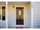 Black front door with sidelights and red welcome mat at 362 Mcgiboney Rd, Covington, GA 30016