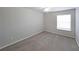 Well-lit bedroom with neutral walls, carpet, and window with blinds at 1707 Brighton Point, Sandy Springs, GA 30328