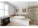 Elegant bathroom with a large soaking tub and a walk-in shower at 2100 Davis Academy Rd, Rutledge, GA 30663