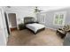 Bright bedroom with a large bed, ample closet space, and a sitting area at 2100 Davis Academy Rd, Rutledge, GA 30663