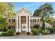 Brick house with a large front porch and landscaping at 2100 Davis Academy Rd, Rutledge, GA 30663