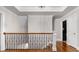 Upper hallway with hardwood floors and railing at 2100 Davis Academy Rd, Rutledge, GA 30663