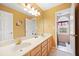 Bathroom with double sink, large mirror, and ample lighting at 5711 Brynwood Nw Cir, Acworth, GA 30101