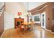 Bright dining room with vaulted ceiling, brick fireplace, wood floors, and large window at 5711 Brynwood Nw Cir, Acworth, GA 30101