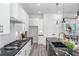 Modern kitchen with white cabinets, black countertops and island at 2312 Herring Sw Rd, Atlanta, GA 30311