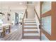 Modern staircase with light wood treads and a metal railing at 2312 Herring Sw Rd, Atlanta, GA 30311