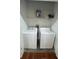 Bright laundry room with washer and dryer and overhead shelving at 250 Pharr Ne Rd # 507, Atlanta, GA 30305