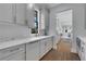 Kitchen features gray cabinets, quartz countertops, and a view to the backyard at 3227 Ivanhoe Nw Dr, Atlanta, GA 30327