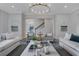 Elegant living room with a statement chandelier and neutral decor at 3227 Ivanhoe Nw Dr, Atlanta, GA 30327