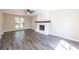 Living room with hardwood floors, fireplace and ceiling fan at 557 Old Friar Tuck Ln, Stone Mountain, GA 30087