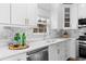 Modern kitchen with white cabinets, stainless steel appliances, and marble countertops at 929 Magnolia Leaf Dr, Woodstock, GA 30188