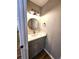 Small bathroom with gray vanity and a round mirror at 2501 Bradford Sq, Atlanta, GA 30345