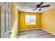 Simple bedroom with wood-look floors and large window at 3447 Portsmouth Cir, Stonecrest, GA 30038