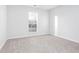 Spacious bedroom with neutral carpeting and large window at 4100 Chanticleer Nw Dr, Kennesaw, GA 30152