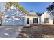 Inviting one-story house featuring a 2-car garage, tidy yard, and classic white siding at 4100 Chanticleer Nw Dr, Kennesaw, GA 30152