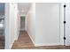 Clean hallway with wood-look vinyl flooring and neutral paint at 4100 Chanticleer Nw Dr, Kennesaw, GA 30152