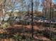 Aerial view of house nestled in a wooded lot with fall foliage at 5375 Northland Ne Dr, Sandy Springs, GA 30342